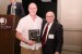 Dr. Nagib Callaos, General Chair, giving Dr. Ashton T. Sperry a plaque "In Appreciation for Delivering a Great Keynote Address at a Plenary Session."